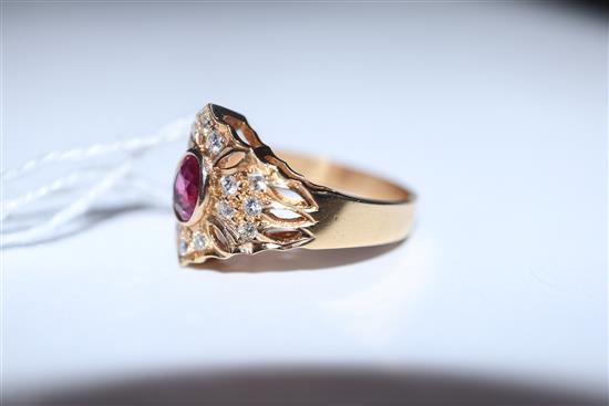 A modern pierced 14ct gold, ruby and diamond hexagonal cluster ring, size N/O.